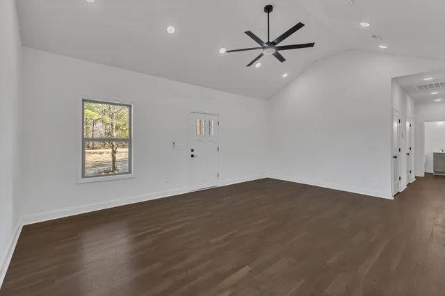 a view of a room with wooden floor and windows