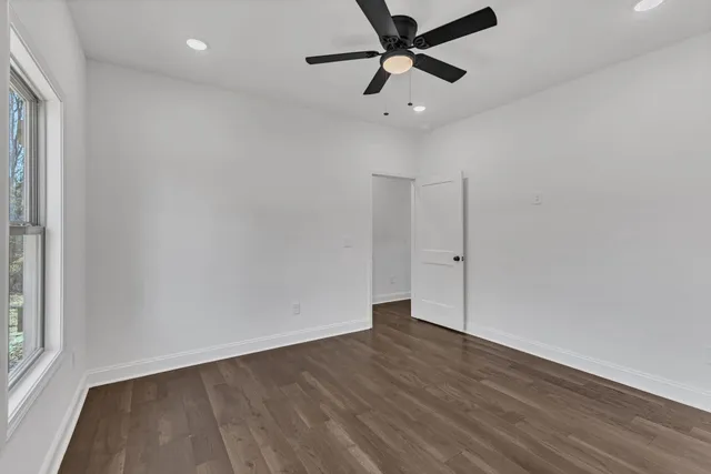 a front view of a house with a yard and trees