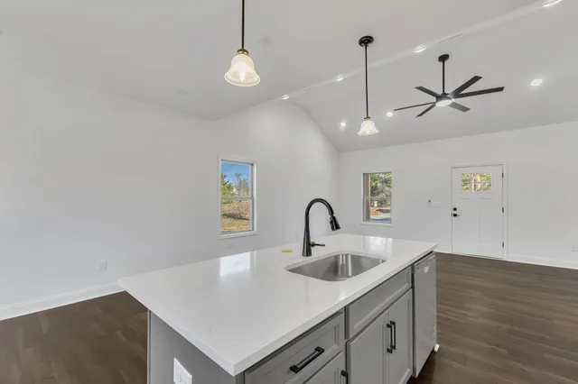 a kitchen with stainless steel appliances a sink a stove and a microwave