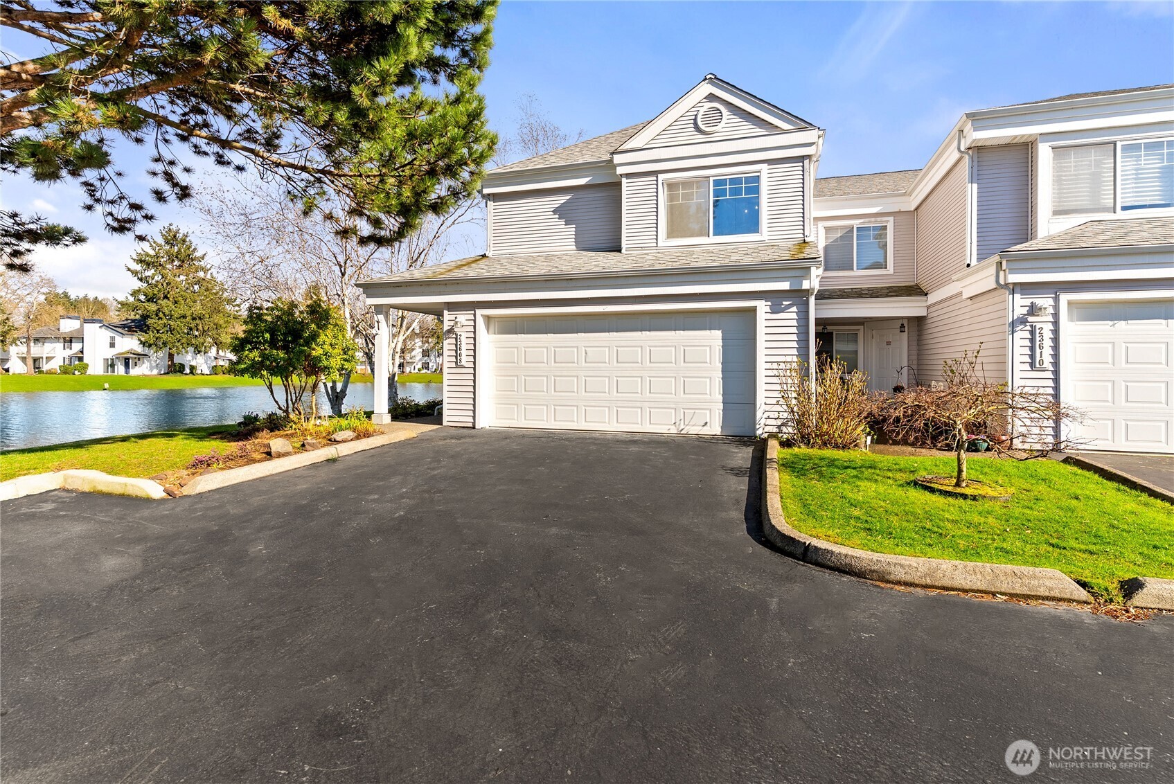 a view of a house with a swimming pool and a yard