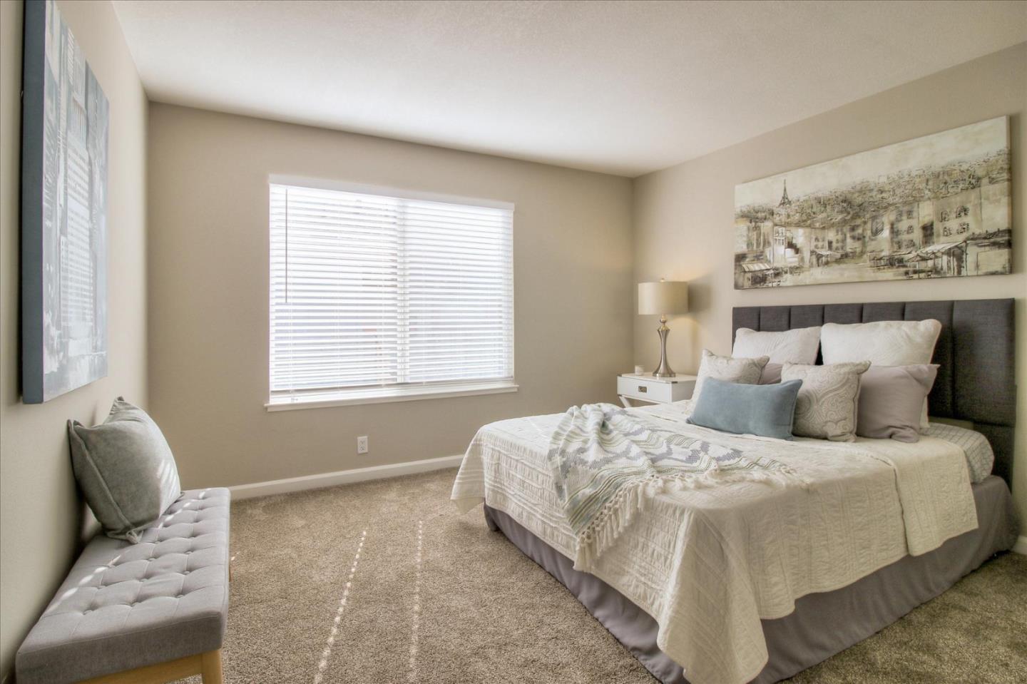 84 Rancho Drive, Unit H San Jose, CA 95111 - Photo 11 of 27 a bedroom with a large bed and couch