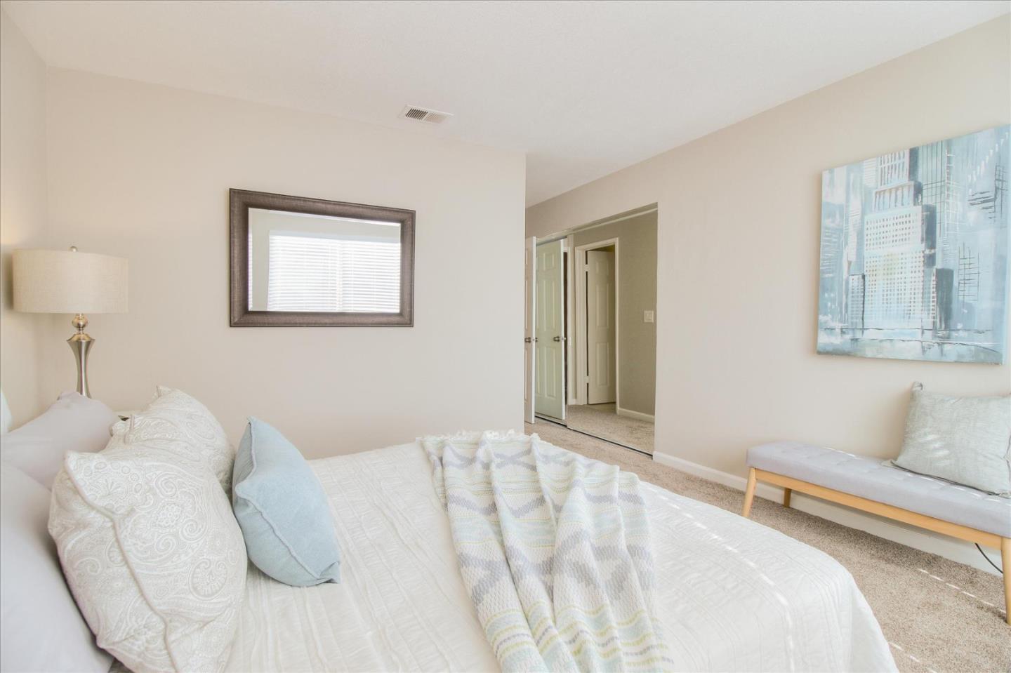 84 Rancho Drive, Unit H San Jose, CA 95111 - Photo 13 of 27 a bedroom with a bed and a couch
