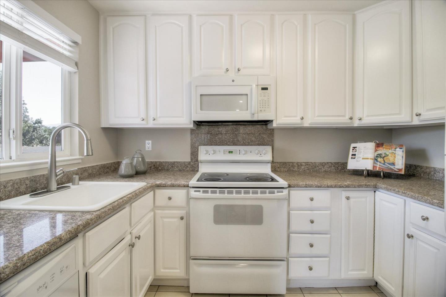 84 Rancho Drive, Unit H San Jose, CA 95111 - Photo 19 of 27 a kitchen with granite countertop white cabinets and white appliances
