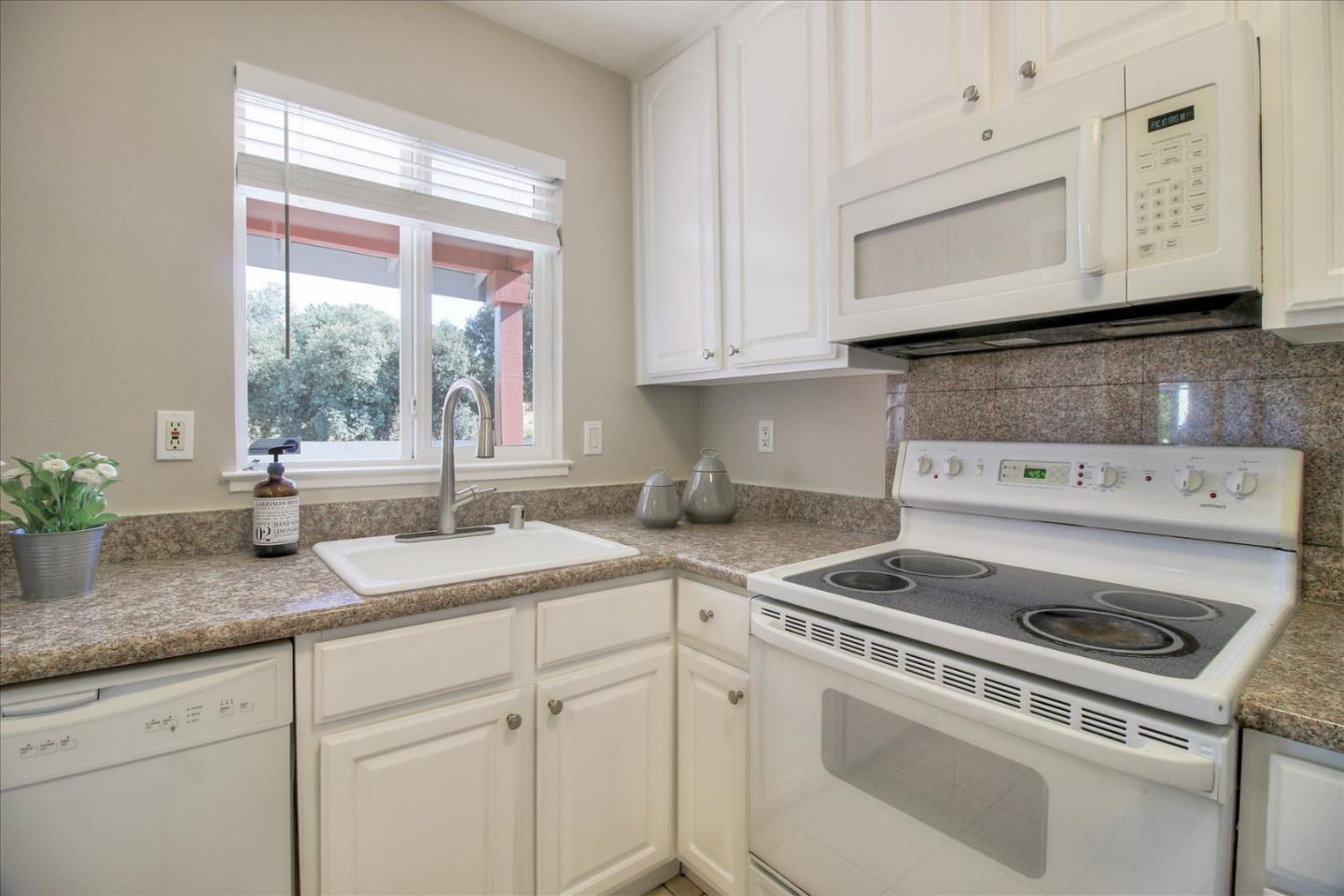 84 Rancho Drive, Unit H San Jose, CA 95111 - Photo 21 of 27 a kitchen with granite countertop white cabinets and white appliances