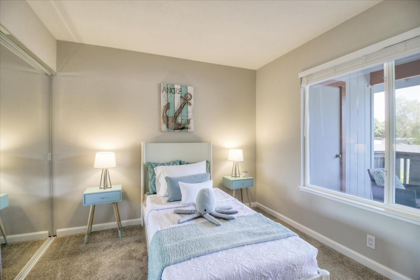 84 Rancho Drive, Unit H San Jose, CA 95111 - Photo 9 of 27 a bedroom with a bed and a night stand