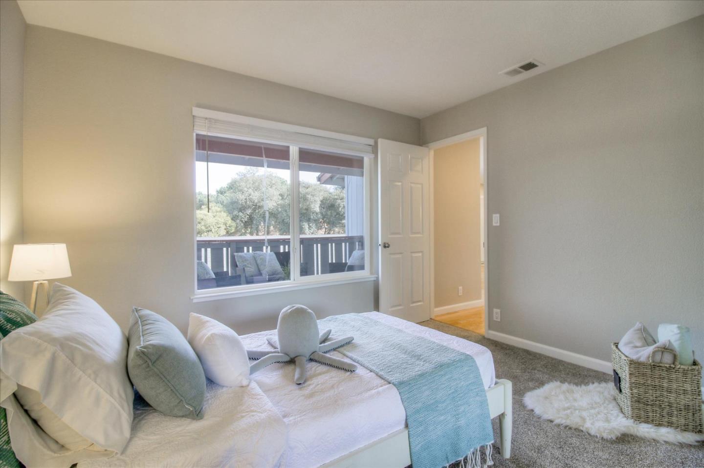84 Rancho Drive, Unit H San Jose, CA 95111 - Photo 10 of 27 a bedroom with a bed and wooden floor