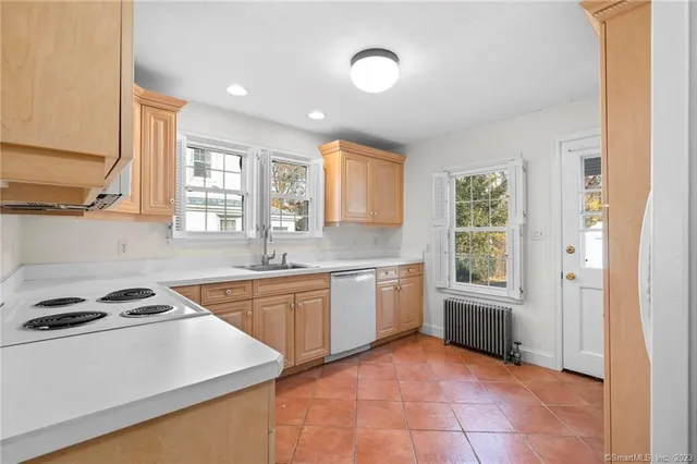 a kitchen that has a sink a stove and window