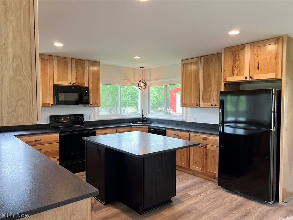 550 Johnson Road Wadsworth, OH 44281 - Photo 4 of 40 Kitchen with sink, light hardwood / wood-style floors, a kitchen island, and black appliances