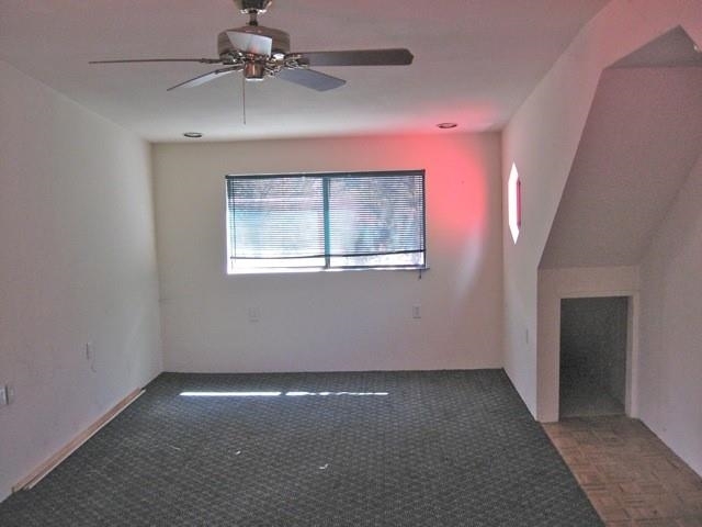 2146 Rimview Trail Overgaard, AZ 85933 - Photo 3 of 23 an empty room with a chandelier fan and windows