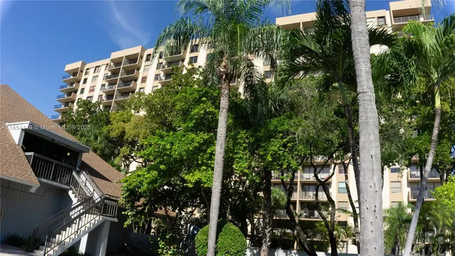 a front view of a multi story building with yard