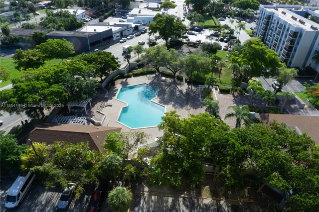 an aerial view of a house with a yard and lake view