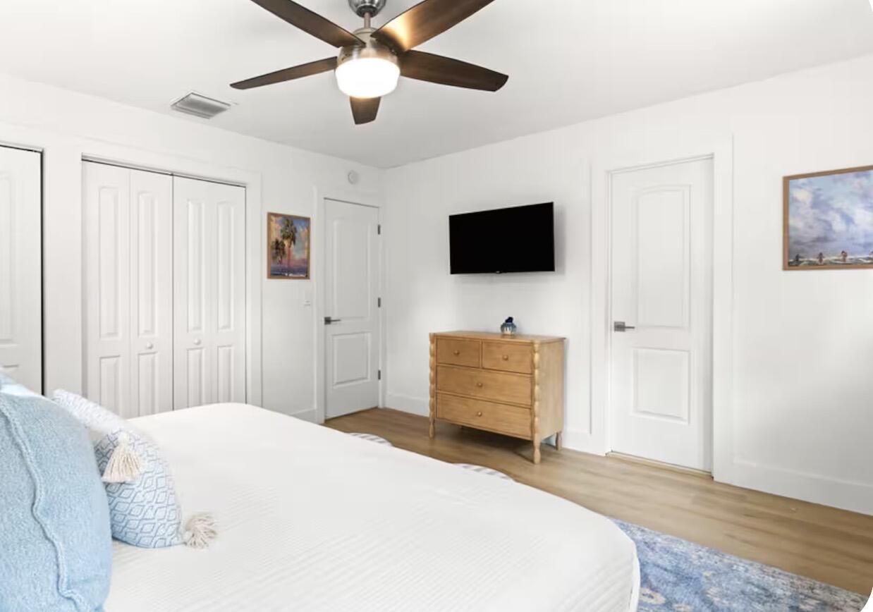 1216 Surf Road Singer Island, FL 33404 - Photo 4 of 15 a bedroom with a bed and a flat screen tv