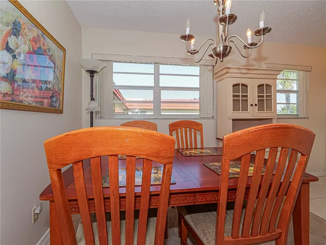 a bedroom with a bed a table and chair