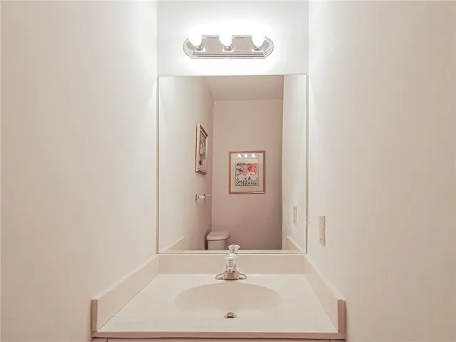 a bedroom with a bed a table and window