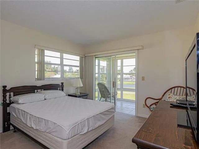 a bedroom with a bed a table and chair