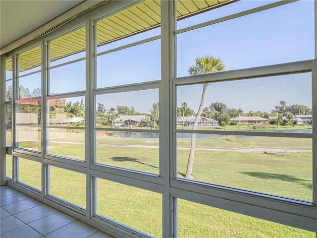 a kitchen view with a glass table and windows