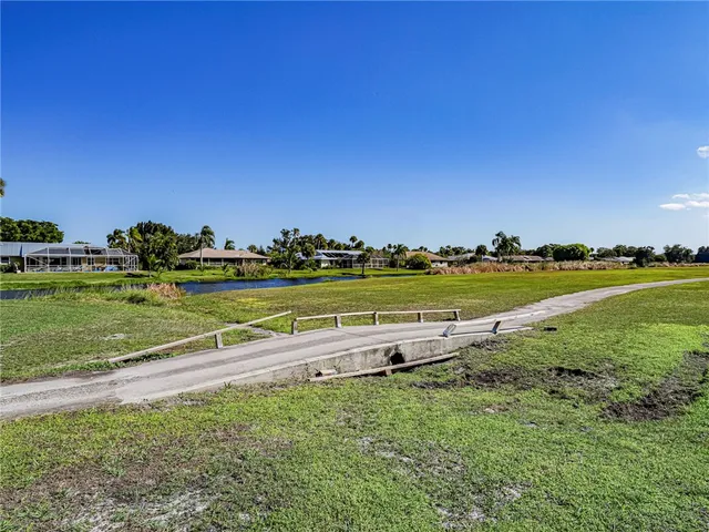 a view of a lake with houses in the back