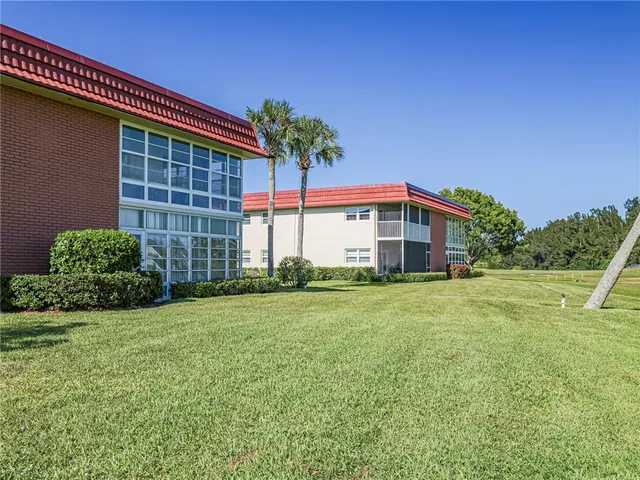 a view of a backyard with swimming pool
