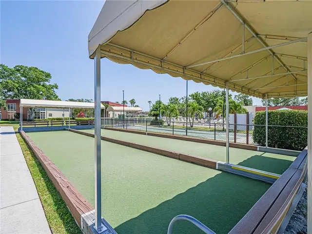 a view of a swimming pool with outdoor seating and plants