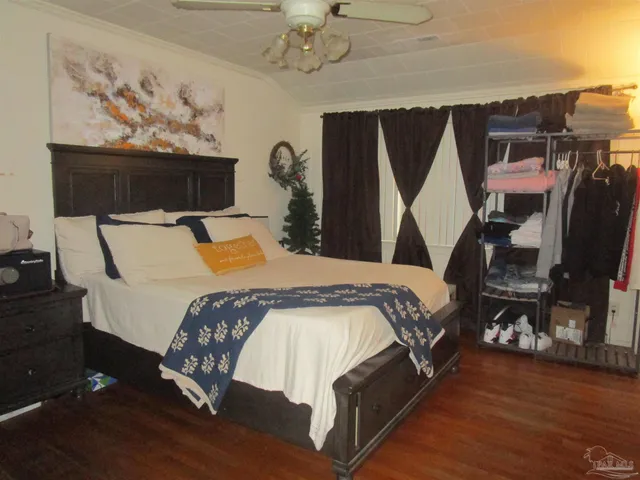 a bed sitting in a bedroom next to a cabinet