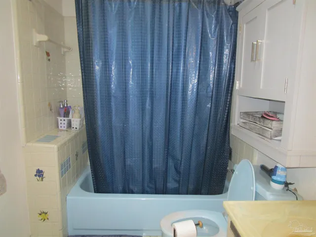 a bathroom with a tub and shower