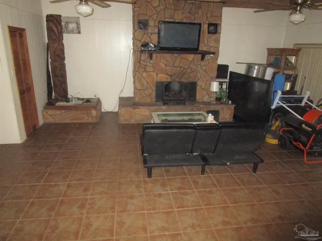 a living room with furniture a flat screen tv and a fireplace
