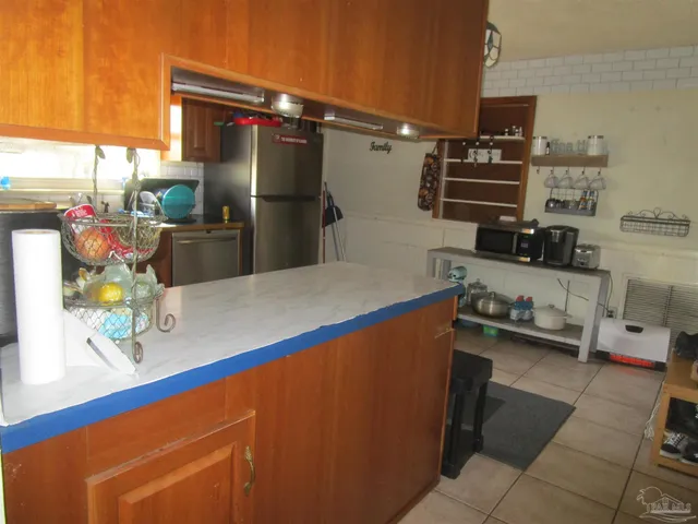 a kitchen with refrigerator and stove
