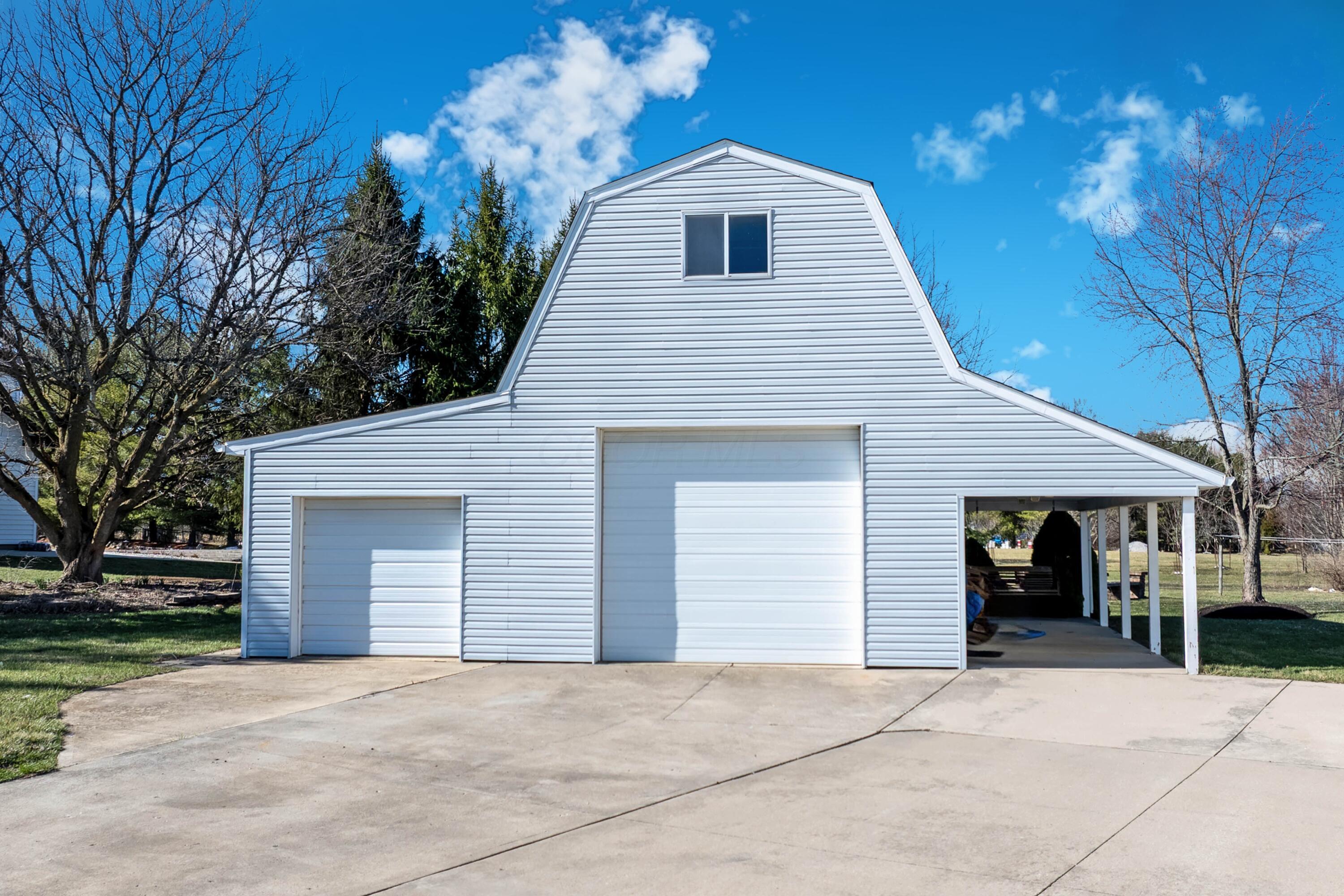 1364 Dale Ford Road Delaware, OH 43015 - Photo 83 of 112 • Vinyl exterior • Lean-to with concrete flooring • Concrete floor • Finished walls • (2) mini splits • Interior speakers • Insulated door • Man door • Shared driveway sealed ~ 2024 • 200 amp panel • Garage keyless entry keypad • Shop equipment does not remain • Dust collection pipes remain