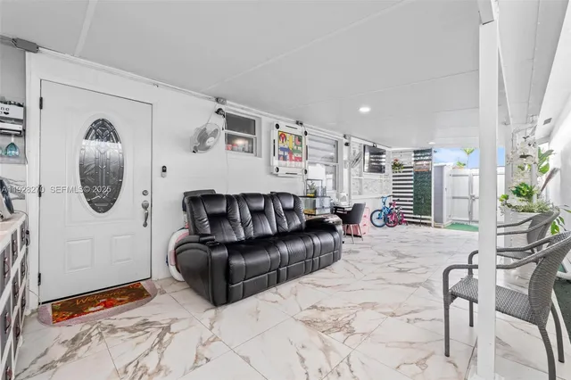 a living room with furniture a rug and a large window