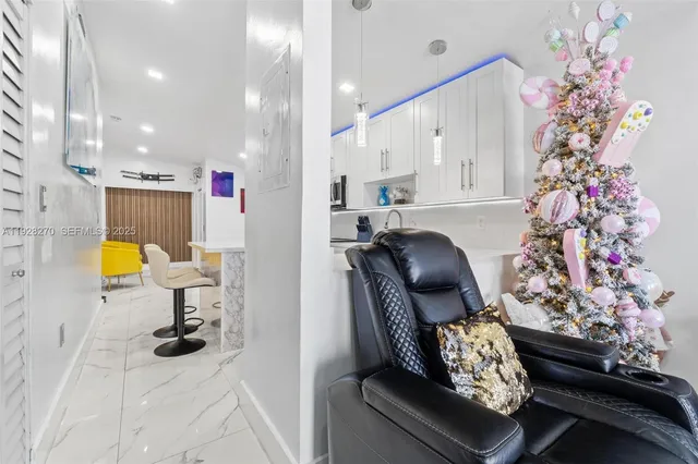 a living room with furniture and flowers