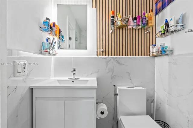 a bathroom with a sink toilet and a mirror
