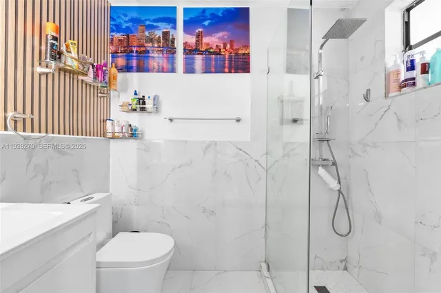 a bathroom with a toilet sink and shower curtain