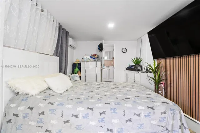 a large white bed in a white room