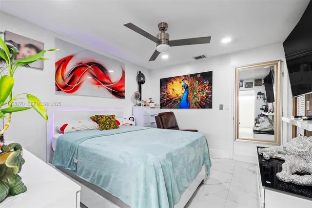 a bedroom with a bed a window and dresser