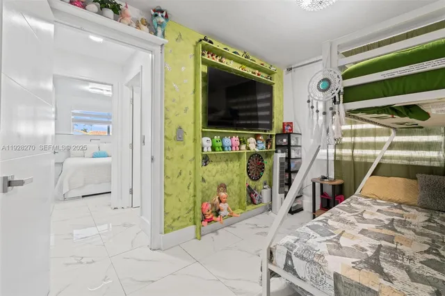 a bed room with a bed and a television