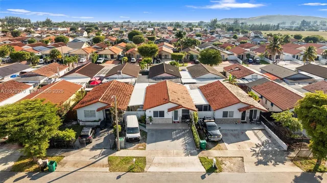 an aerial view of residential houses with outdoor space