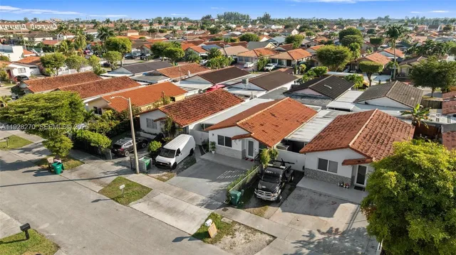 an aerial view of residential houses with outdoor space