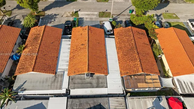 an aerial view of residential houses with outdoor space
