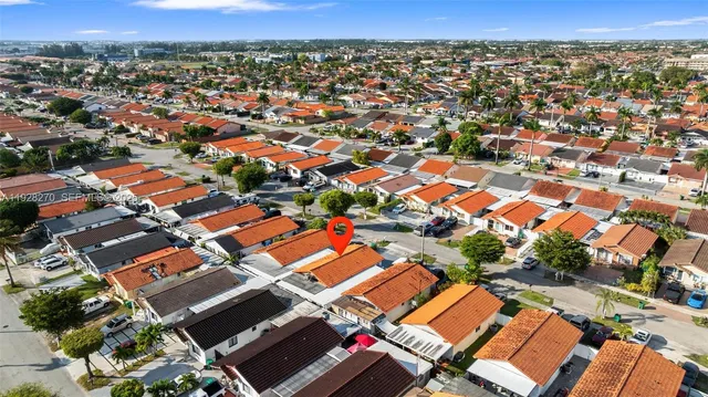 an aerial view of residential houses with city view