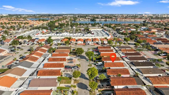 an aerial view of residential building and lake