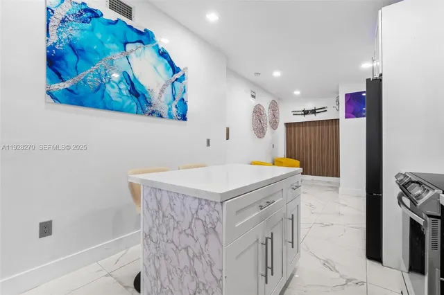 a kitchen that has a lot of cabinets in it