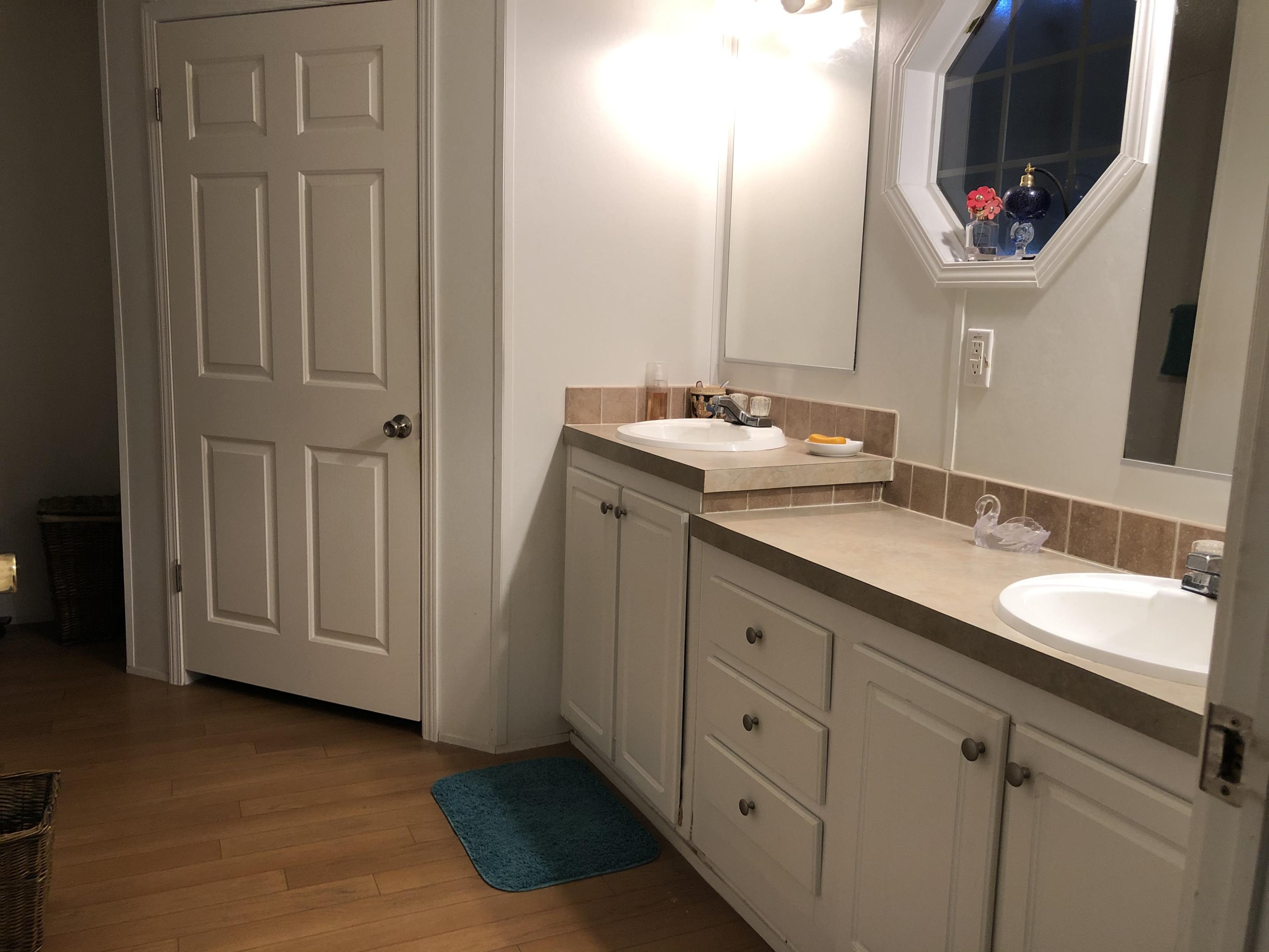 22884 Neptune Road Boca Raton, FL 33428 - Photo 11 of 19 a bathroom with a sink and a mirror