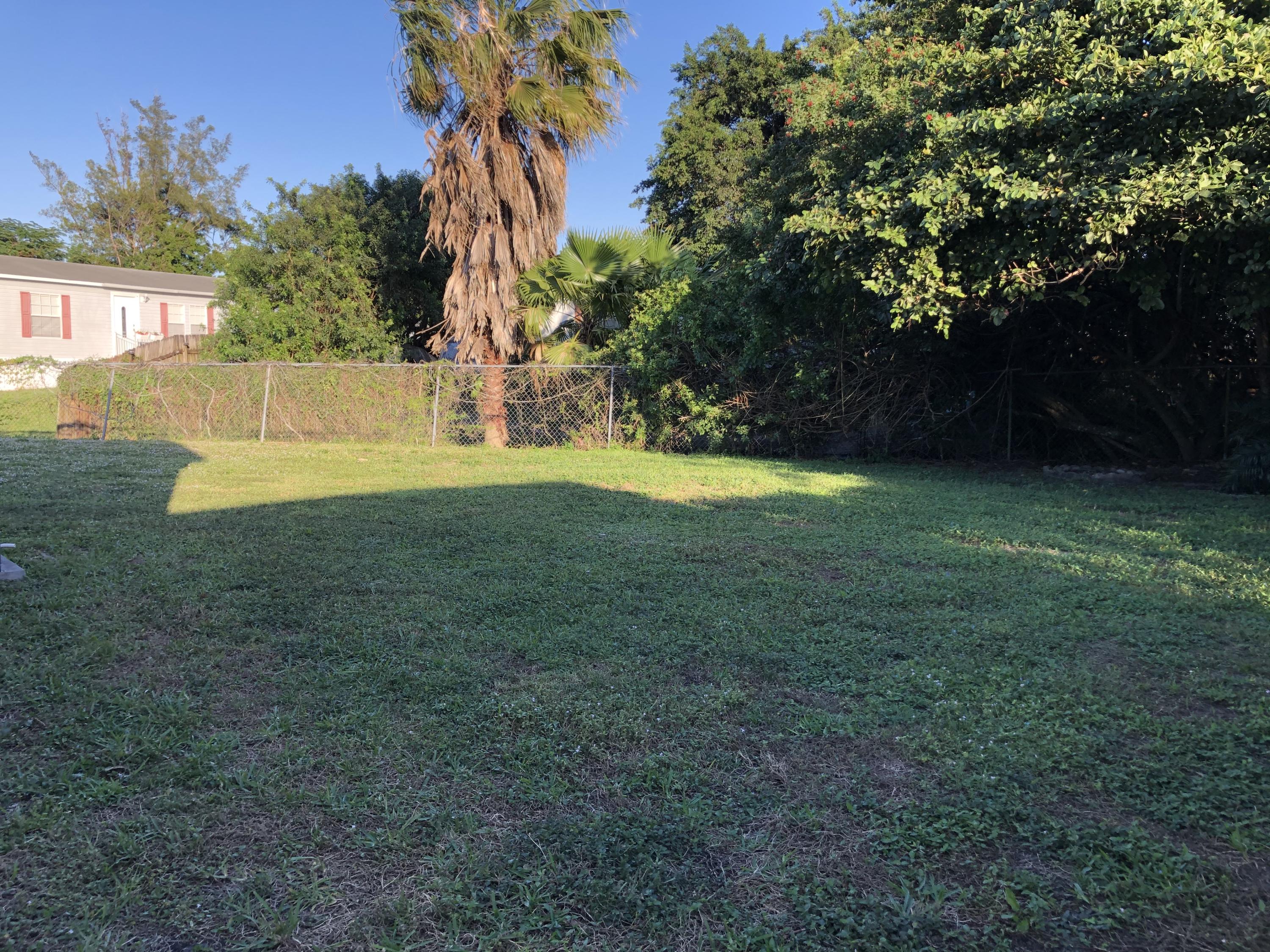 22884 Neptune Road Boca Raton, FL 33428 - Photo 16 of 19 a view of a house with a yard