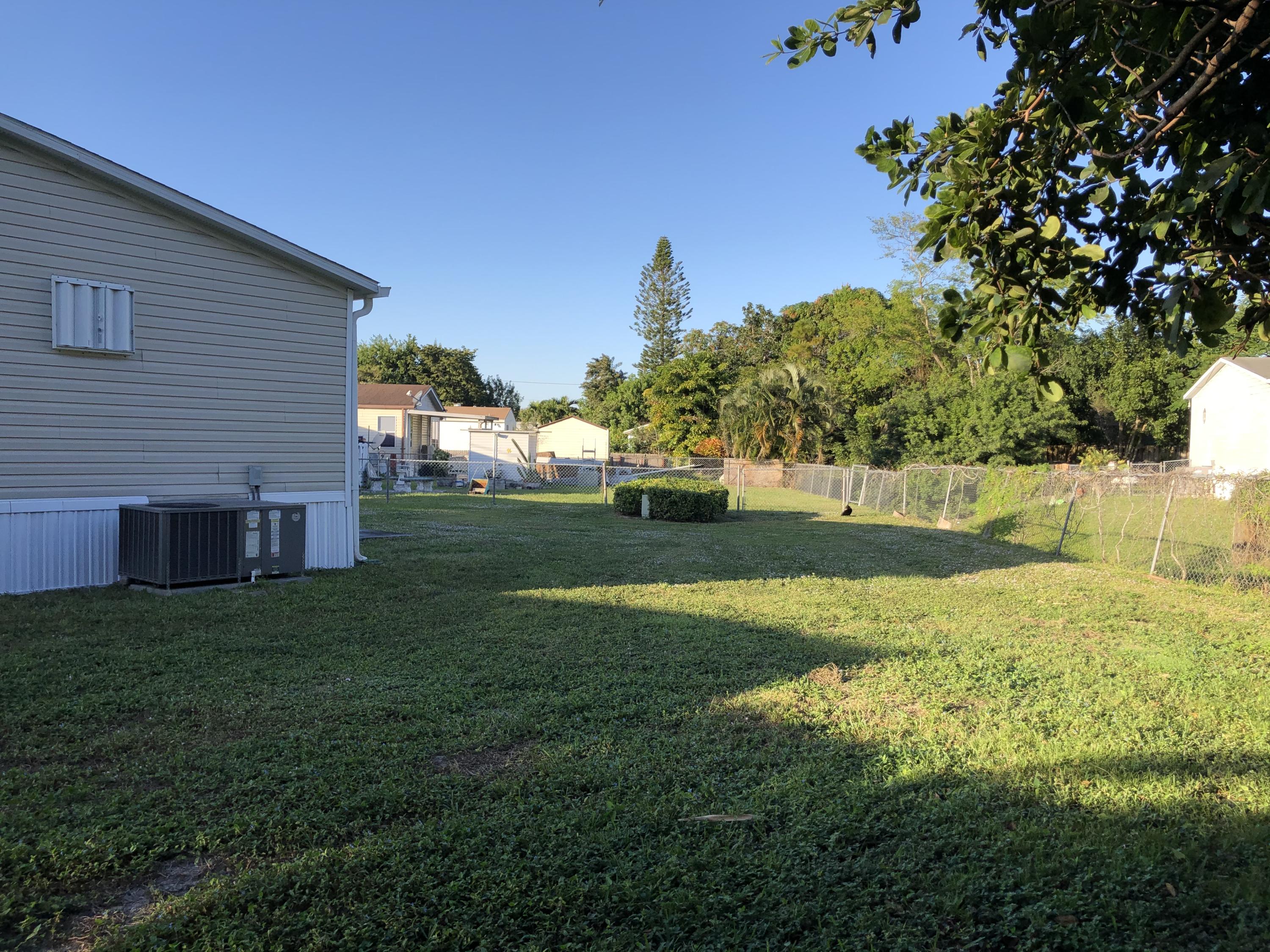 22884 Neptune Road Boca Raton, FL 33428 - Photo 17 of 19 a view of backyard with green space