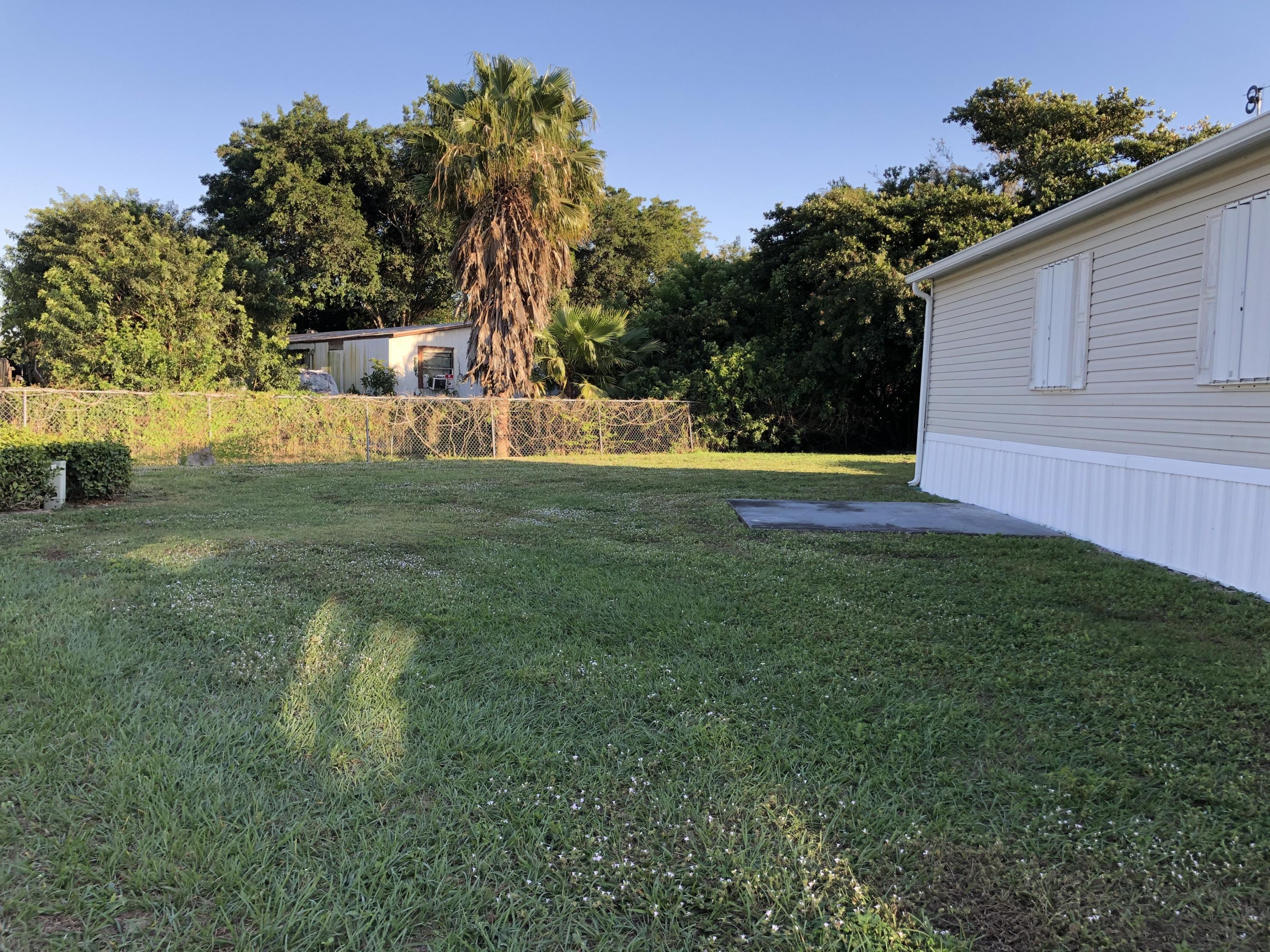 22884 Neptune Road Boca Raton, FL 33428 - Photo 19 of 19 a view of a house with a backyard