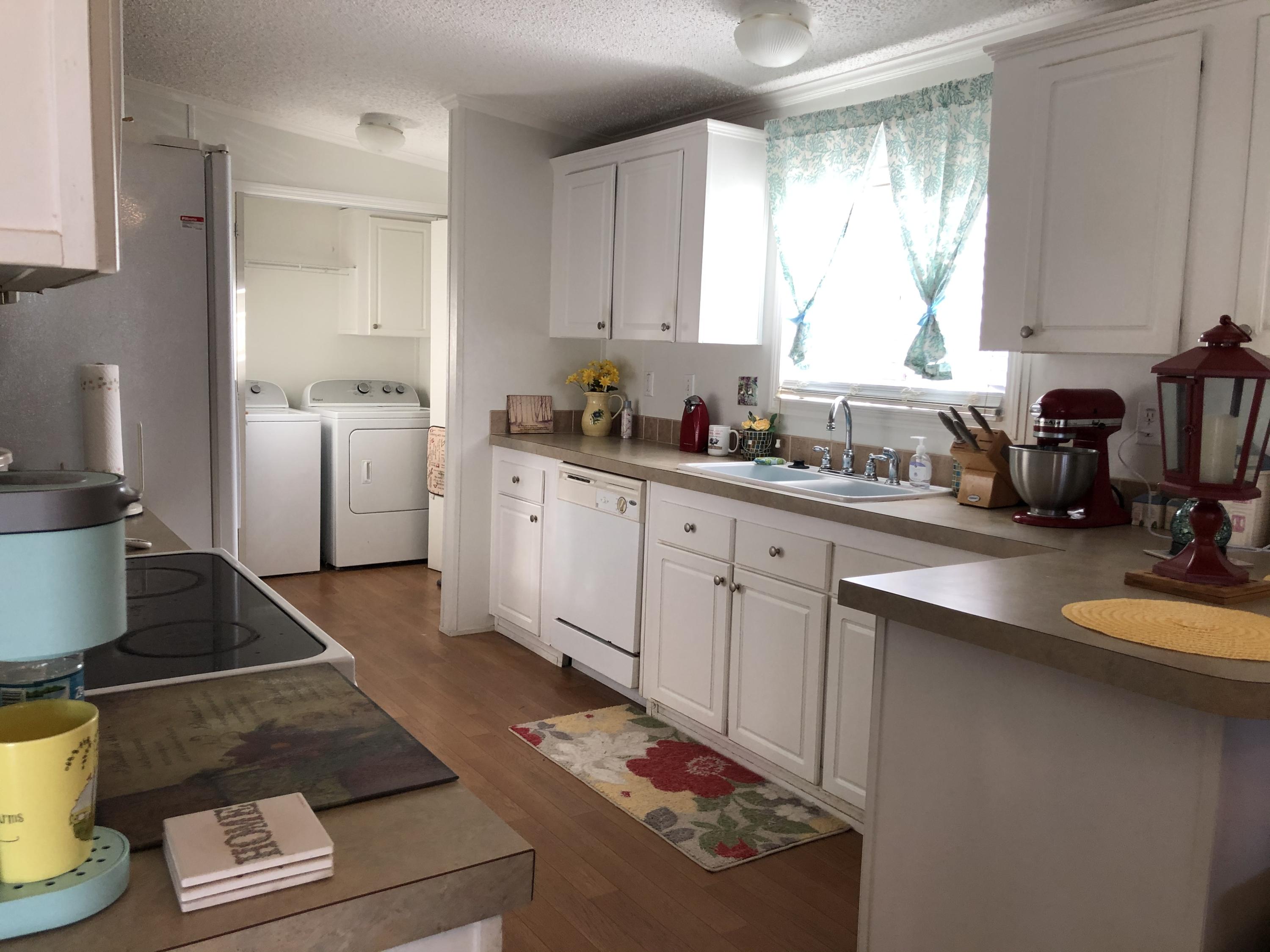 22884 Neptune Road Boca Raton, FL 33428 - Photo 8 of 19 a kitchen with sink refrigerator and window
