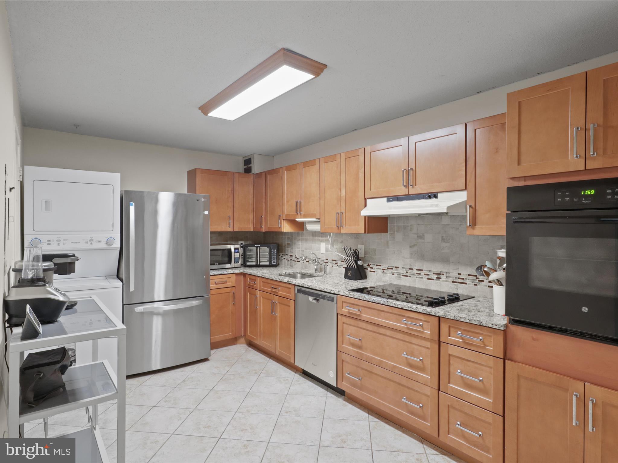 205 Yoakum Parkway, Unit 1020 Alexandria, VA 22304 - Photo 10 of 62 a kitchen with stainless steel appliances granite countertop a refrigerator sink and cabinets