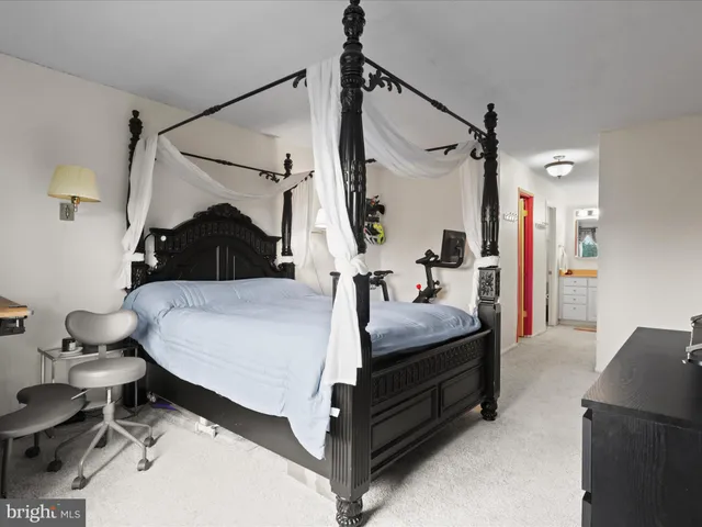 a bed room with a bed and a chair