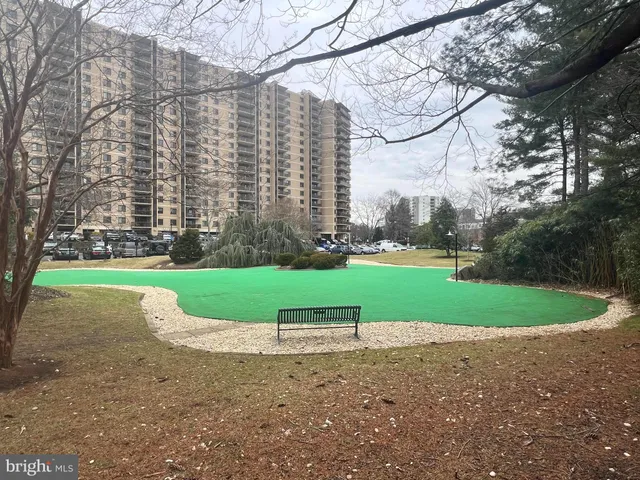 a view of pathway with a yard in front of the house
