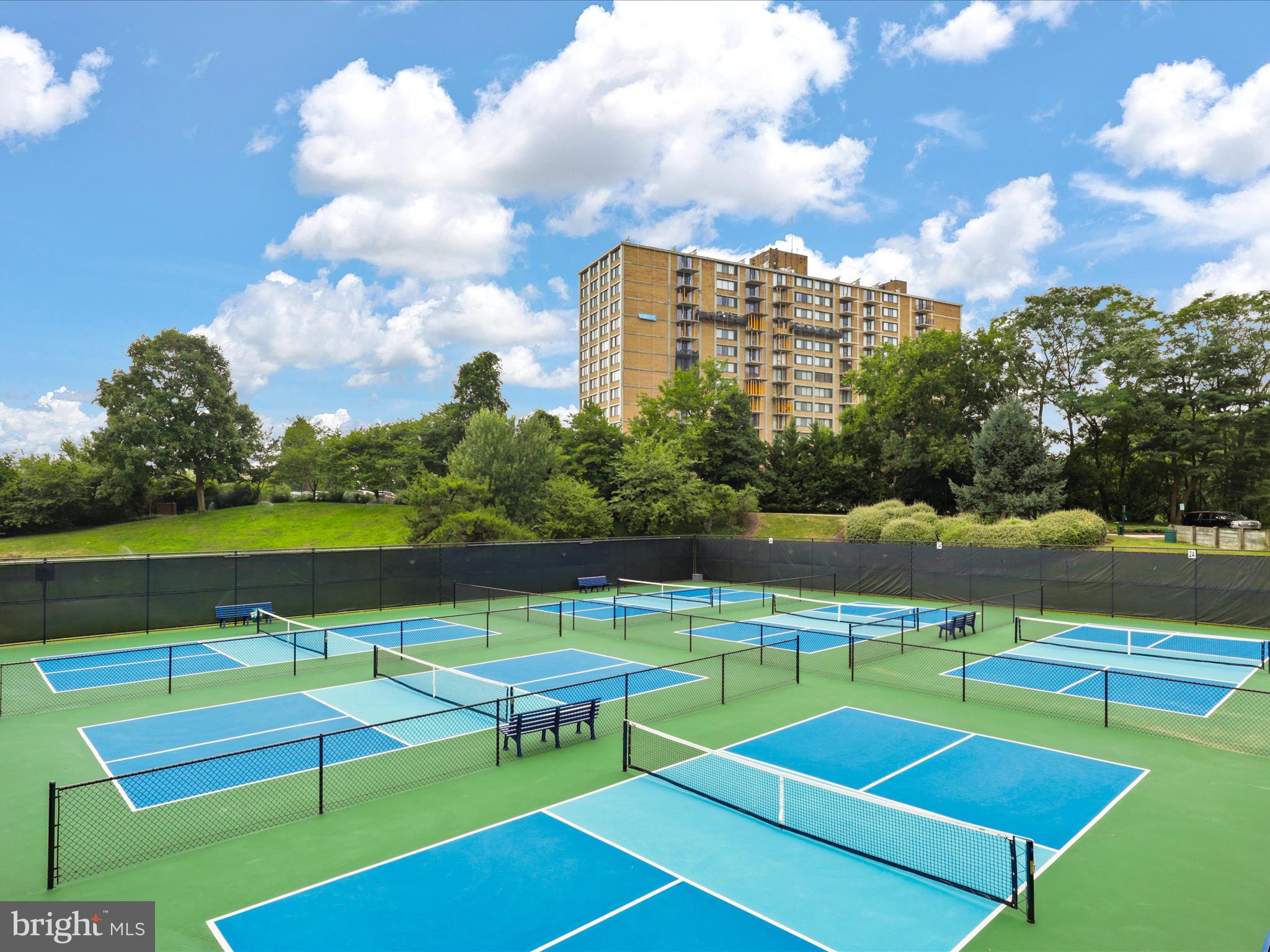 205 Yoakum Parkway, Unit 1020 Alexandria, VA 22304 - Photo 42 of 62 a view of a tennis ground with large trees